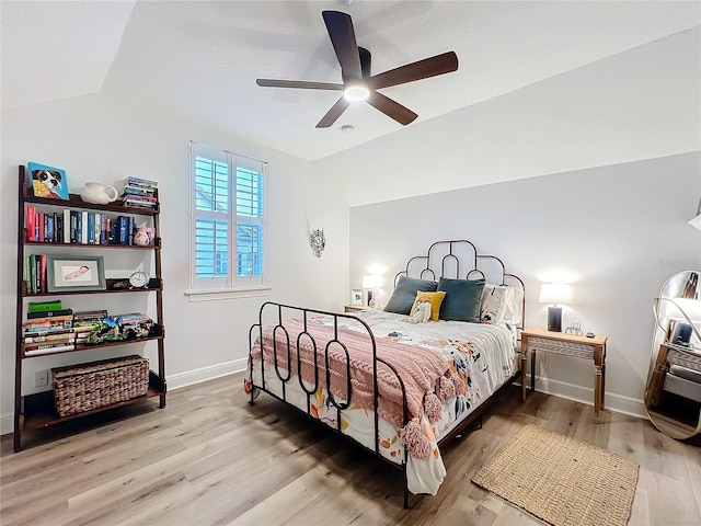 bedroom featuring ceiling fan, baseboards, and wood finished floors