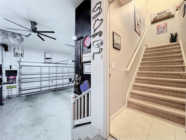 stairway featuring tile patterned flooring, ceiling fan, and baseboards