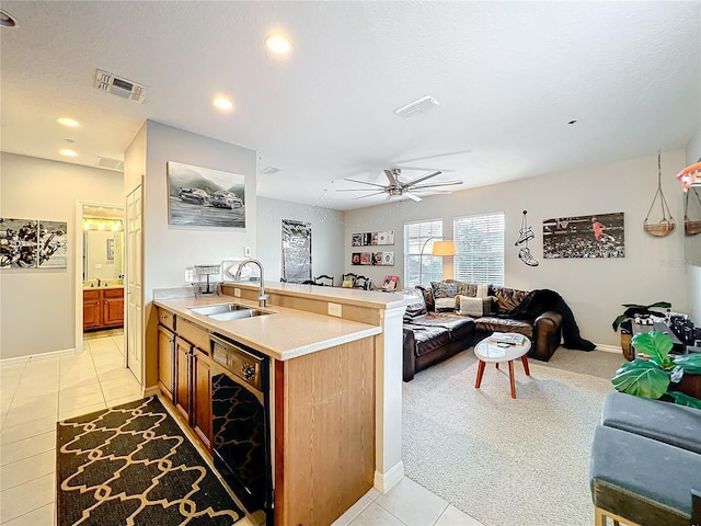 kitchen with visible vents, open floor plan, a sink, and light countertops