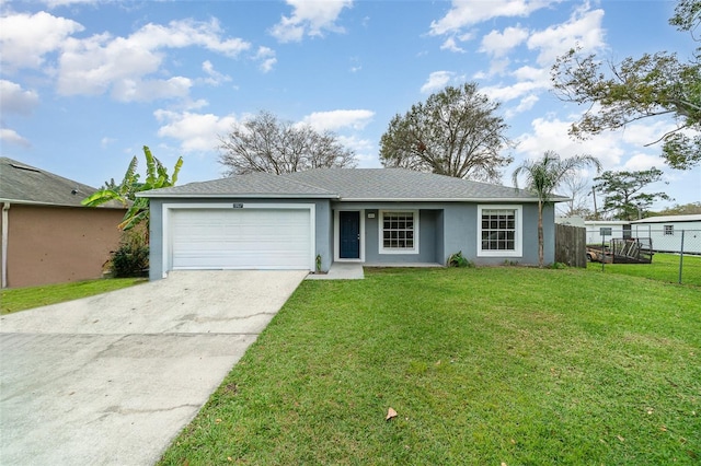 single story home featuring an attached garage, driveway, fence, and a front yard