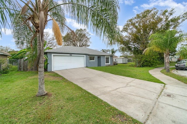 view of front of property featuring driveway, stucco siding, fence, and a front yard