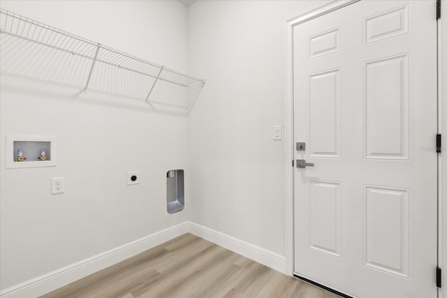 laundry area featuring hookup for a washing machine, hookup for an electric dryer, laundry area, baseboards, and light wood finished floors