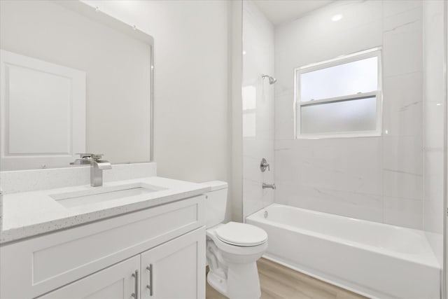 bathroom with toilet, bathtub / shower combination, wood finished floors, and vanity