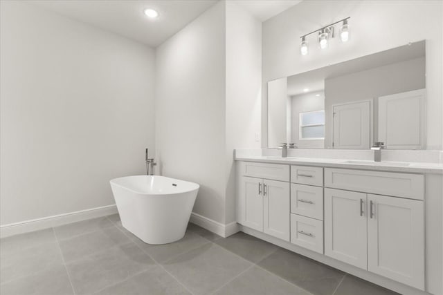 bathroom featuring double vanity, tile patterned flooring, baseboards, and a sink