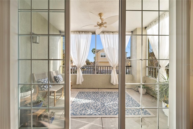 doorway to outside featuring plenty of natural light, a ceiling fan, and tile patterned floors