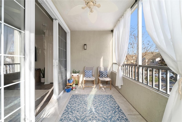 sunroom with a ceiling fan