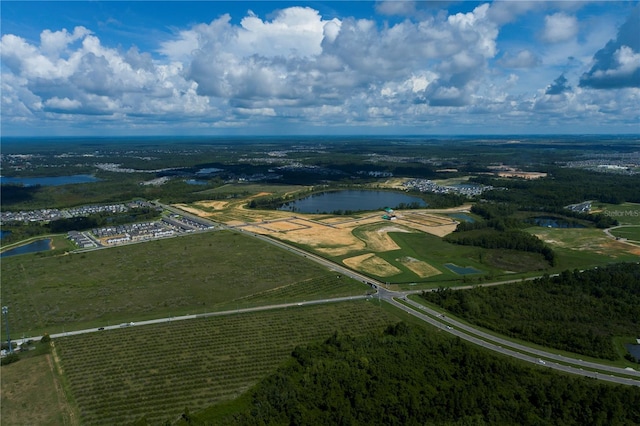 birds eye view of property with a water view and a rural view