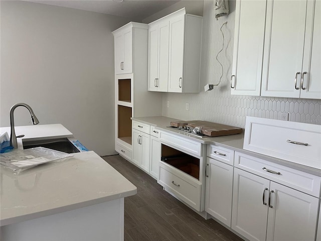 17505 Glossy Pomelo Way, Winter Garden, FL 34787 - kitchen featuring dark wood-type flooring, white cabinetry, light countertops, cooktop, and an office area