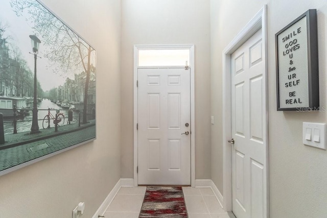 entryway featuring baseboards and light tile patterned floors