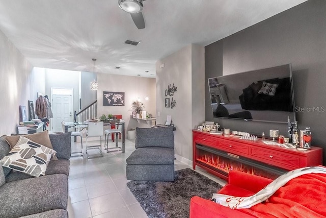 17437 Promenade Dr, Clermont, FL 34711 - living area with stairway, a ceiling fan, and tile patterned floors