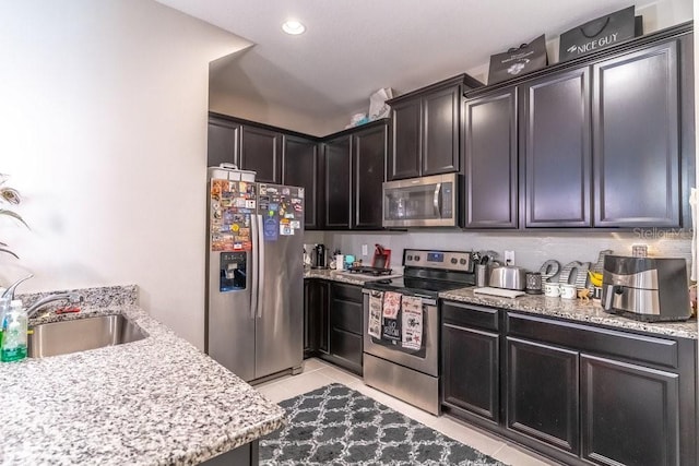 17437 Promenade Dr, Clermont, FL 34711 - kitchen with appliances with stainless steel finishes, light tile patterned floors, light stone countertops, and recessed lighting