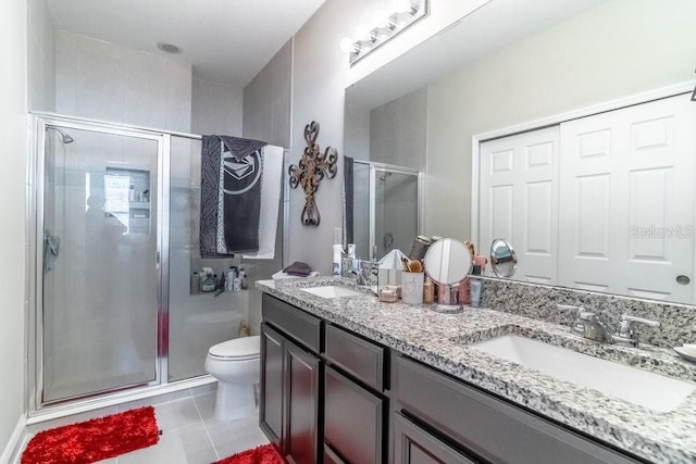 17437 Promenade Dr, Clermont, FL 34711 - full bathroom with double vanity, a shower stall, and tile patterned floors