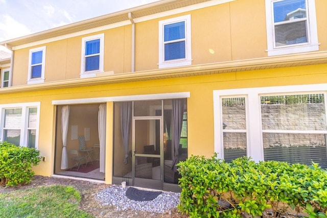 17437 Promenade Dr, Clermont, FL 34711 - rear view of property with stucco siding