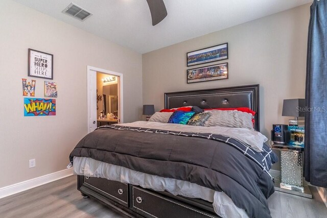 17437 Promenade Dr, Clermont, FL 34711 - bedroom with wood finished floors, connected bathroom, and ceiling fan