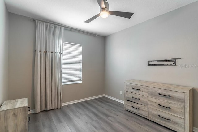 17437 Promenade Dr, Clermont, FL 34711 - unfurnished bedroom featuring wood finished floors and a ceiling fan