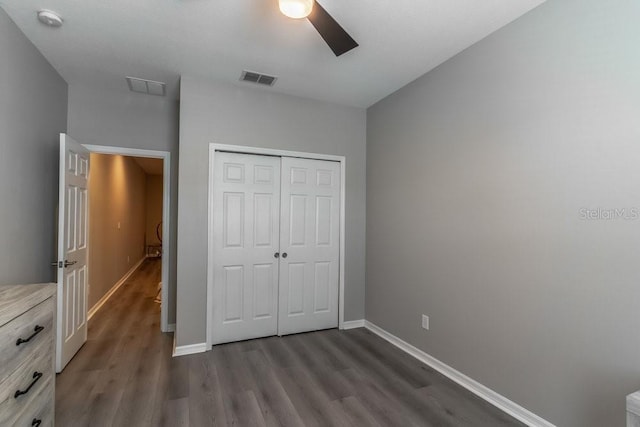 17437 Promenade Dr, Clermont, FL 34711 - unfurnished bedroom with dark wood finished floors, a closet, and a ceiling fan