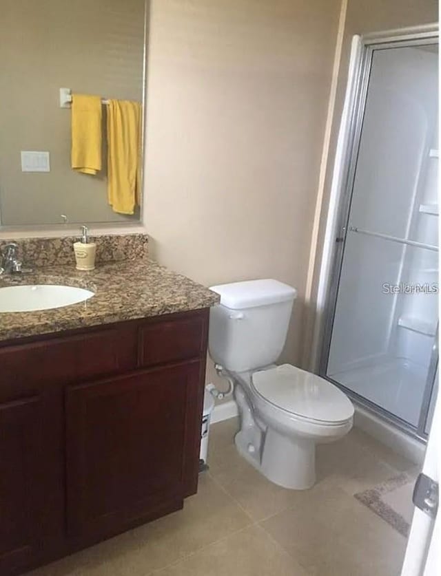 1560 Chelsea Dr, Davenport, FL 33897 - full bathroom with toilet, a shower stall, vanity, and tile patterned floors