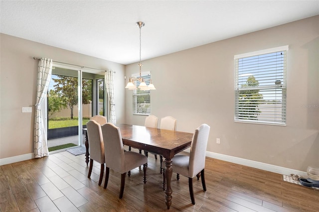 dining room featuring baseboards and wood finished floors