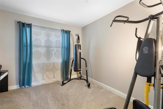 exercise room with carpet and baseboards