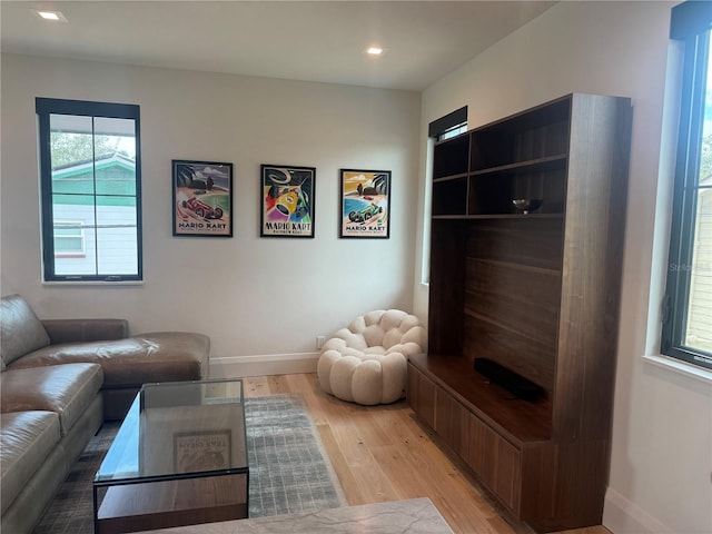 living area featuring recessed lighting, light wood-style flooring, and baseboards