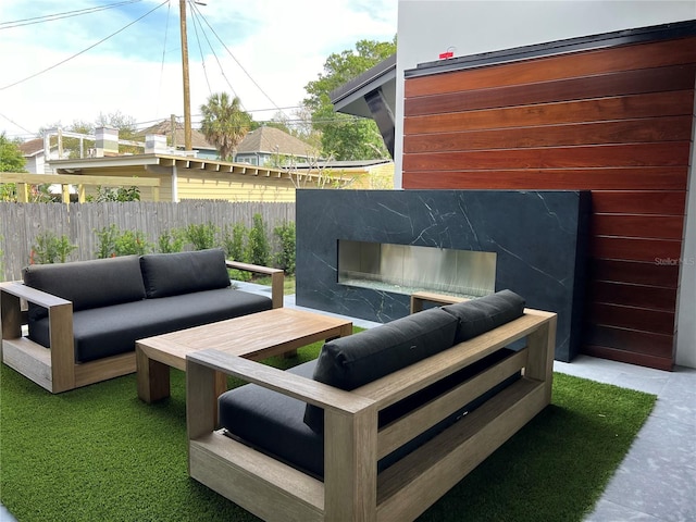 view of patio featuring fence and an outdoor living space