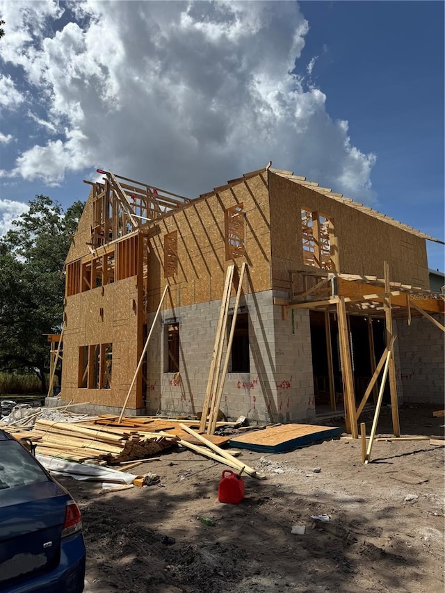rear view of property featuring concrete block siding