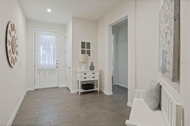 entrance foyer with baseboards and recessed lighting