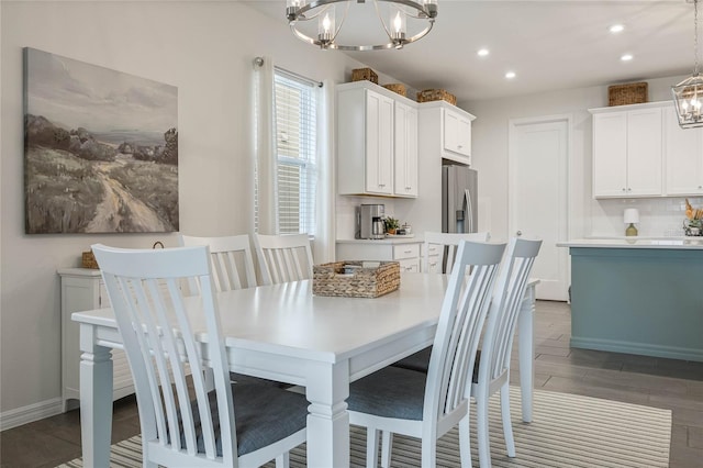 dining space featuring an inviting chandelier, baseboards, and recessed lighting