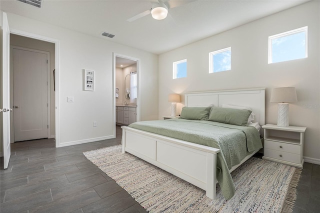 bedroom featuring visible vents, a ceiling fan, wood tiled floor, connected bathroom, and baseboards