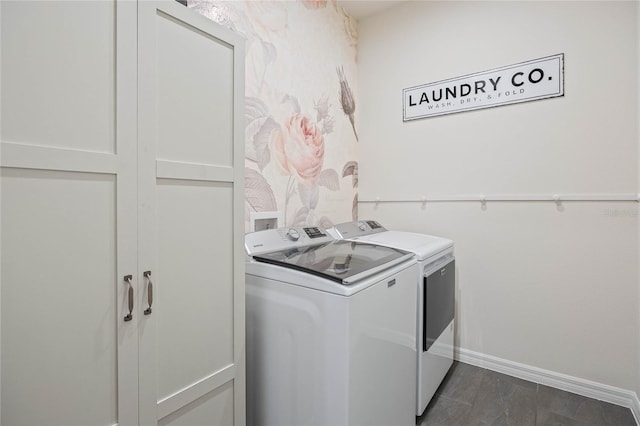 laundry area with laundry area, washer and clothes dryer, and baseboards