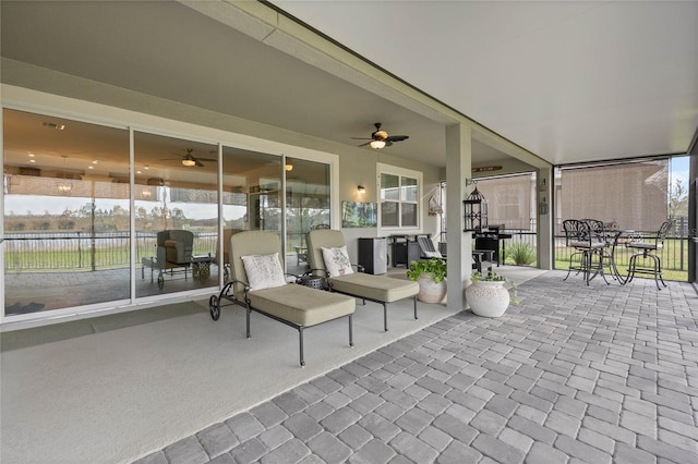 exterior space featuring a ceiling fan and fence