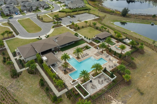 birds eye view of property featuring a water view and a residential view