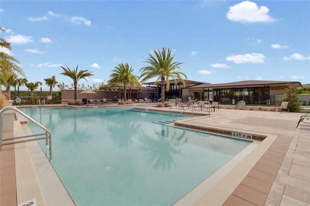 pool featuring a patio area and fence