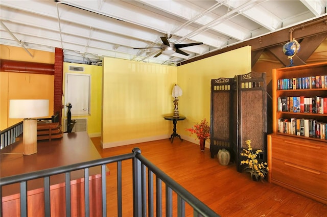 hallway with baseboards and wood finished floors