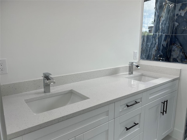 full bathroom with double vanity and a sink