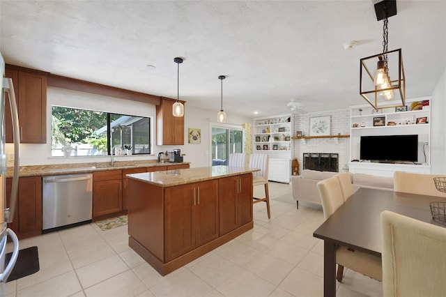 kitchen with built in shelves, a center island, brown cabinetry, a brick fireplace, and dishwasher