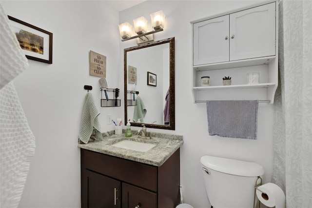 full bathroom with vanity and toilet