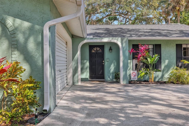 property entrance with stucco siding