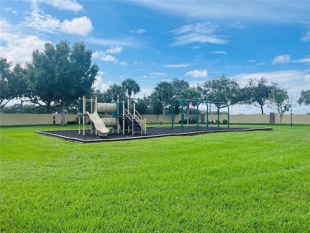 community playground featuring fence and a yard