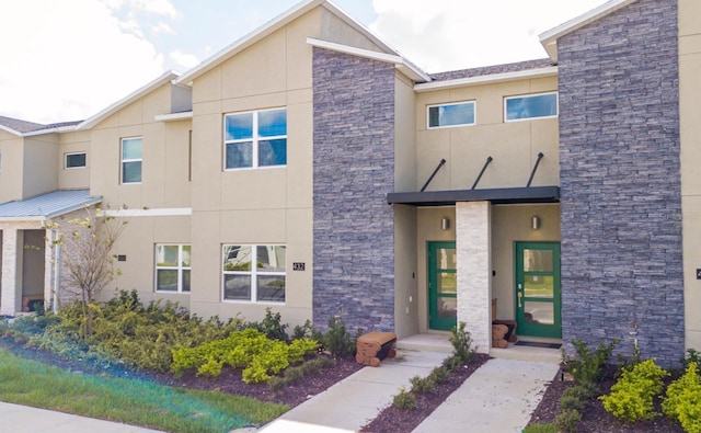 view of front of home with stone siding and stucco siding