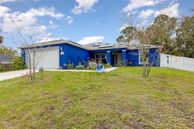 view of front of home featuring a front lawn, fence, and roof mounted solar panels