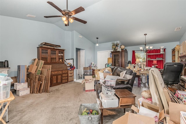 living area with vaulted ceiling, ceiling fan with notable chandelier, visible vents, and carpet