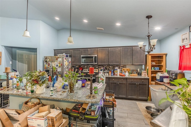 kitchen with light wood-type flooring, dark brown cabinetry, stainless steel appliances, and decorative light fixtures