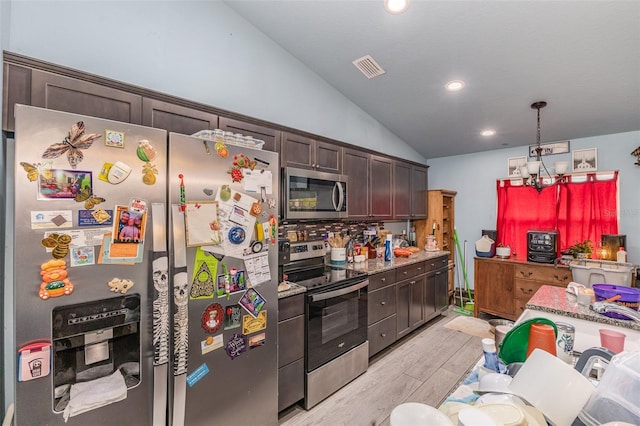 kitchen featuring dark brown cabinetry, lofted ceiling, light wood-style flooring, appliances with stainless steel finishes, and light stone countertops