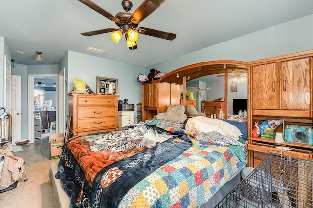 bedroom with arched walkways, visible vents, and a ceiling fan