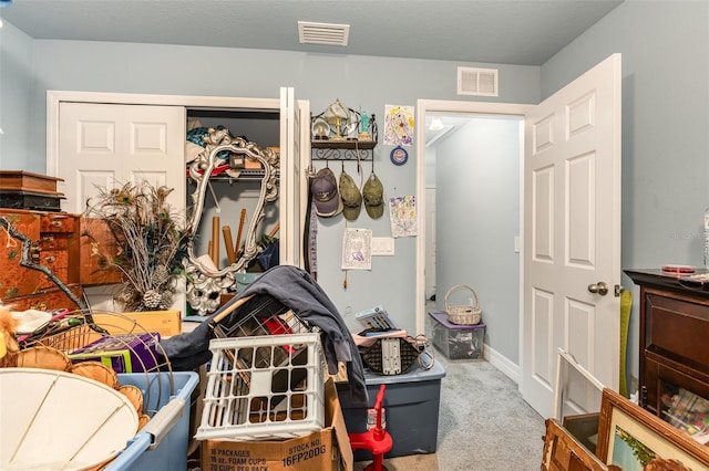 interior space with carpet floors, visible vents, and a closet