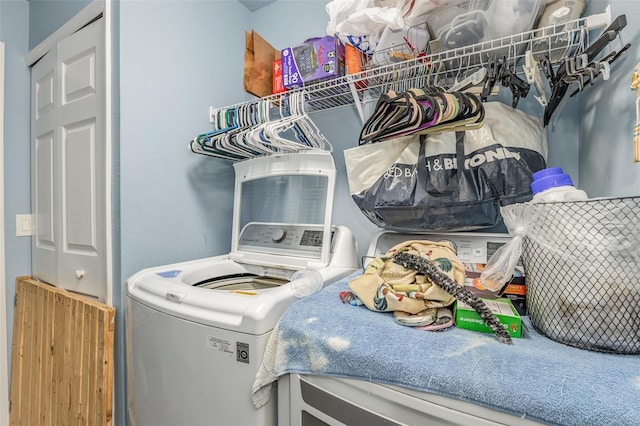 clothes washing area featuring laundry area and separate washer and dryer