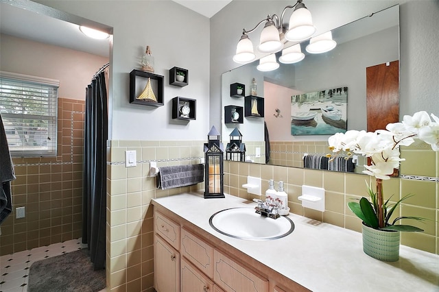 full bath with a wainscoted wall, a shower with shower curtain, vanity, and tile walls