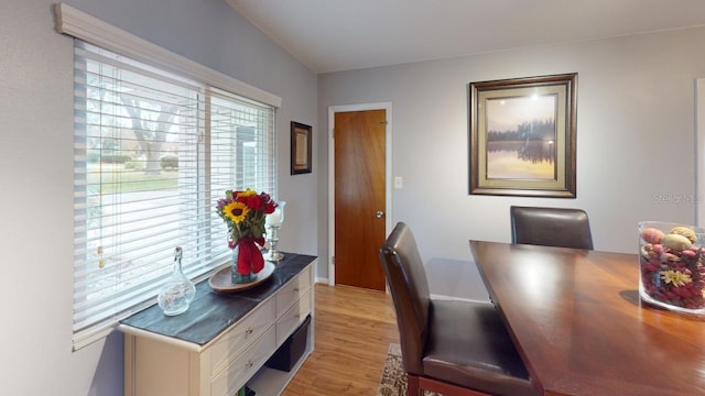 dining room with light wood-type flooring and baseboards