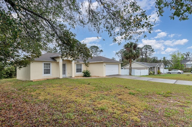 single story home featuring a garage, a front yard, driveway, and stucco siding